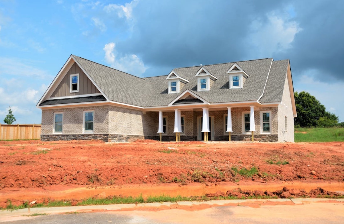 A cozy and inviting suburban house with a well-maintained lawn, symbolizing a stable and supportive sober living environment.