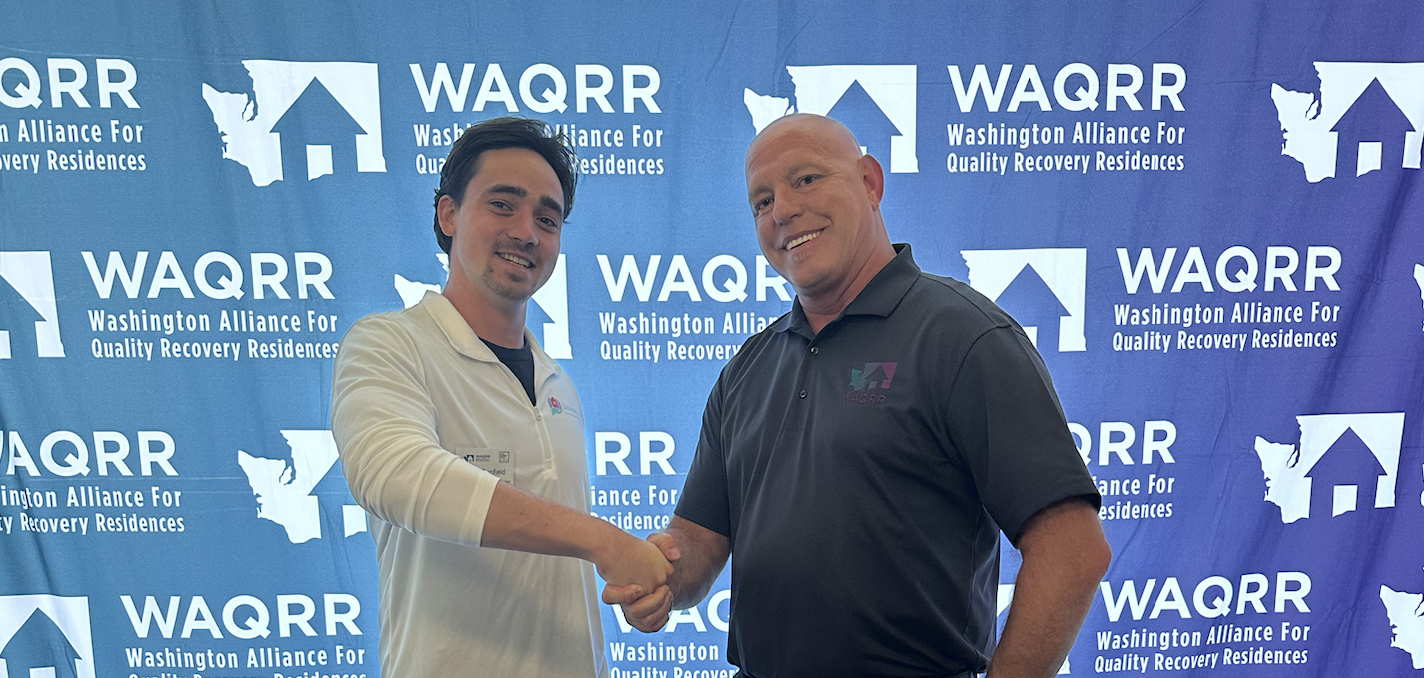 clay canfield and jason bliss (WAQRR executive director) shaking hands