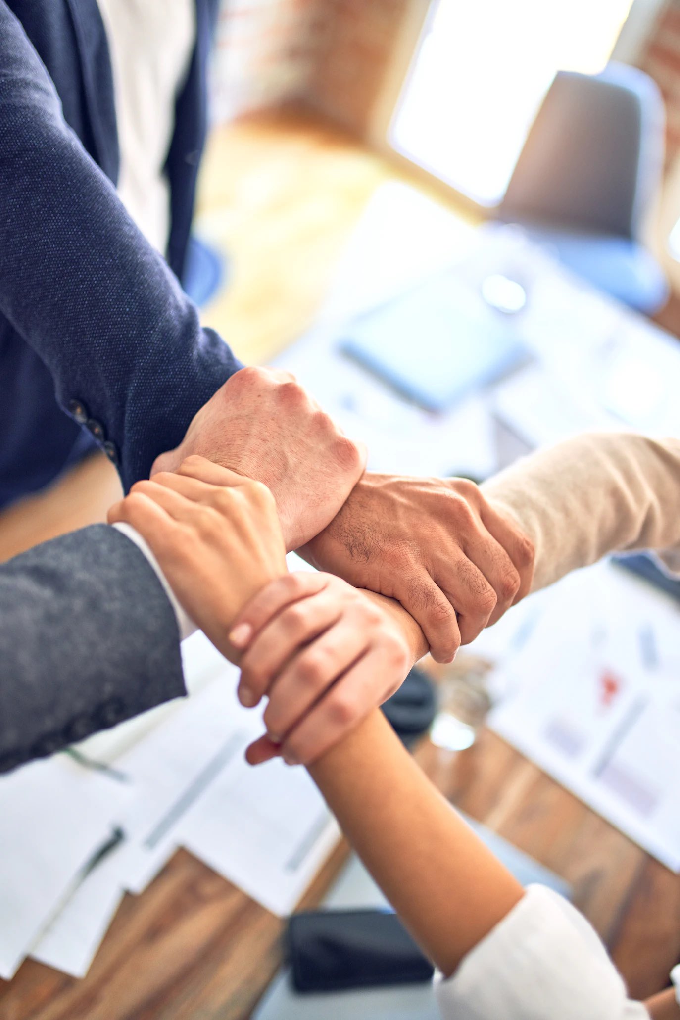 hands of different stakeholders working together 